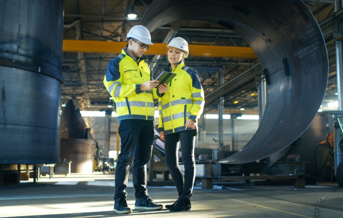 man and woman standing in front of turbine